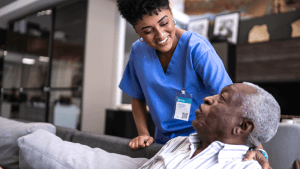 A compassionate caregiver assisting an elderly patient in her home.