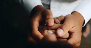Nurse holds interim healthcare patient hand